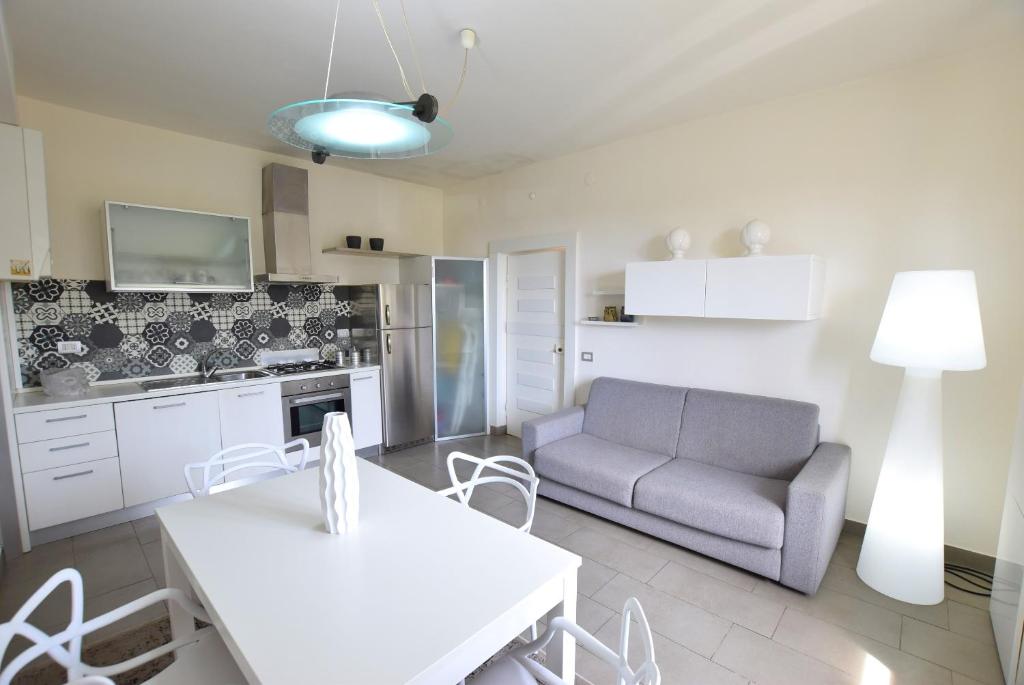 a kitchen and living room with a couch and a table at Marco' s apartment in San Vincenzo
