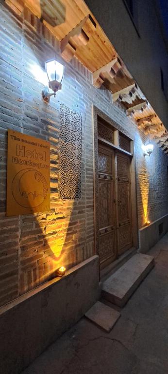 a building with a sign on a brick wall at Boutique Hotel Breshim Terrace in Bukhara