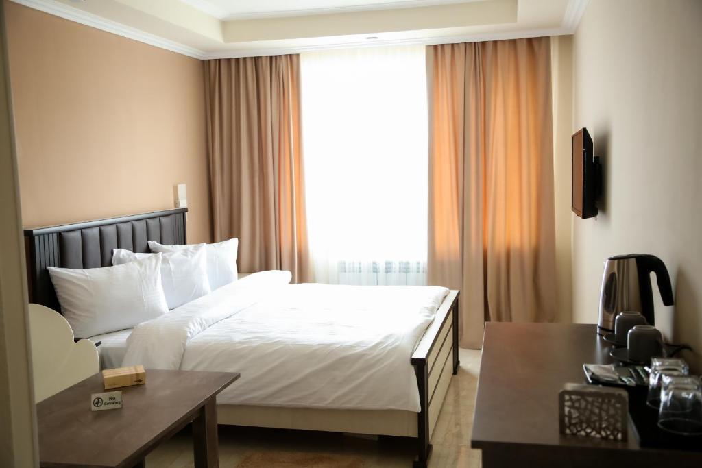 Postel nebo postele na pokoji v ubytování Vell Grey Hotel