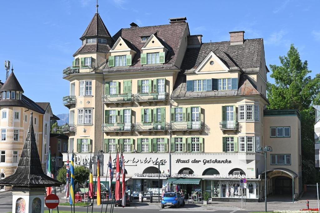 a large building with a turret on top of it at Haus der Geschenke - Carinthia in Velden am Wörthersee