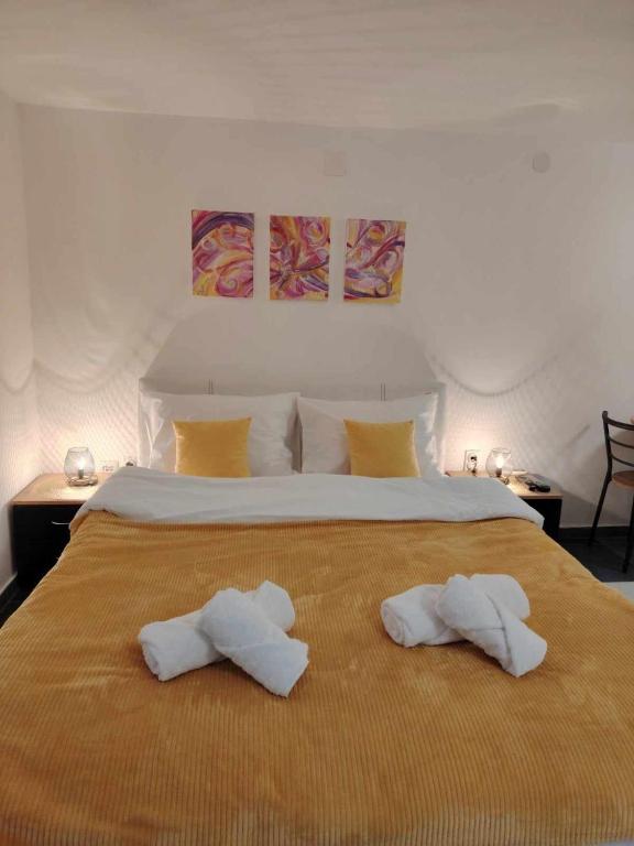 a bedroom with a large bed with towels on it at AGAPE in Leskovac