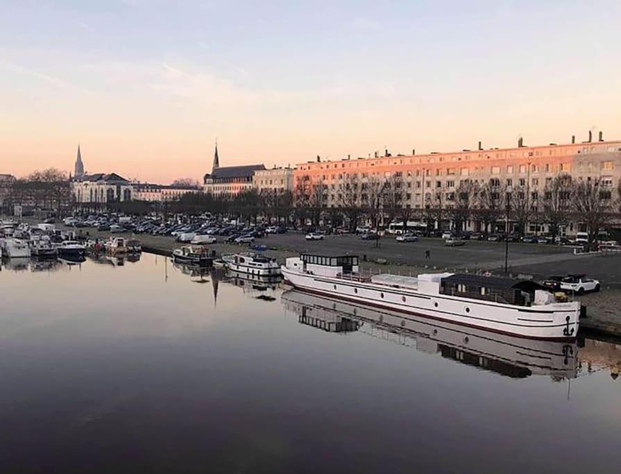 a boat is docked in a harbor in a city at Péniche le Sémaphore in Nantes