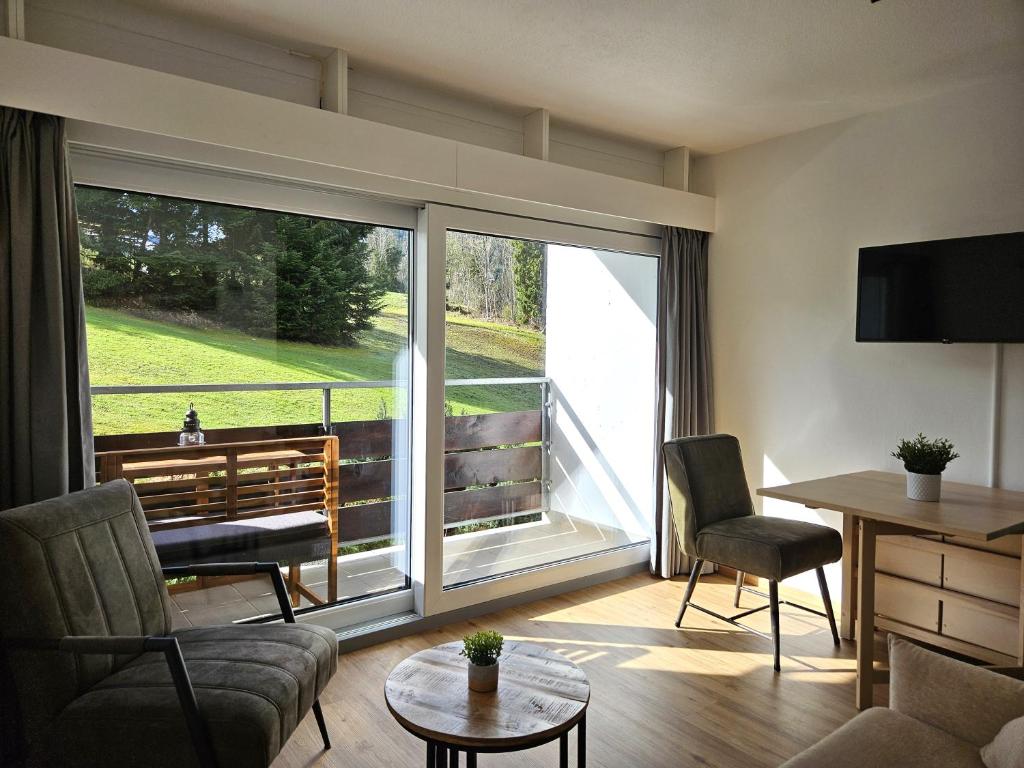 a living room with a large sliding glass door at Alpen Studio Ellmau II in Ellmau