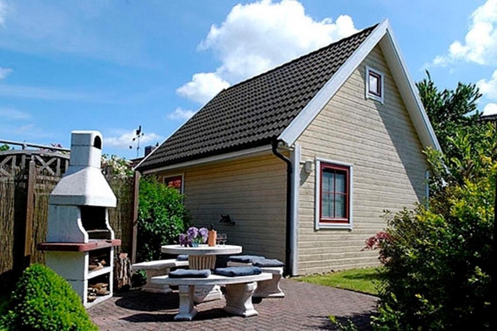ein kleines Haus mit einem Picknicktisch davor in der Unterkunft Damm-Kate in Zingst