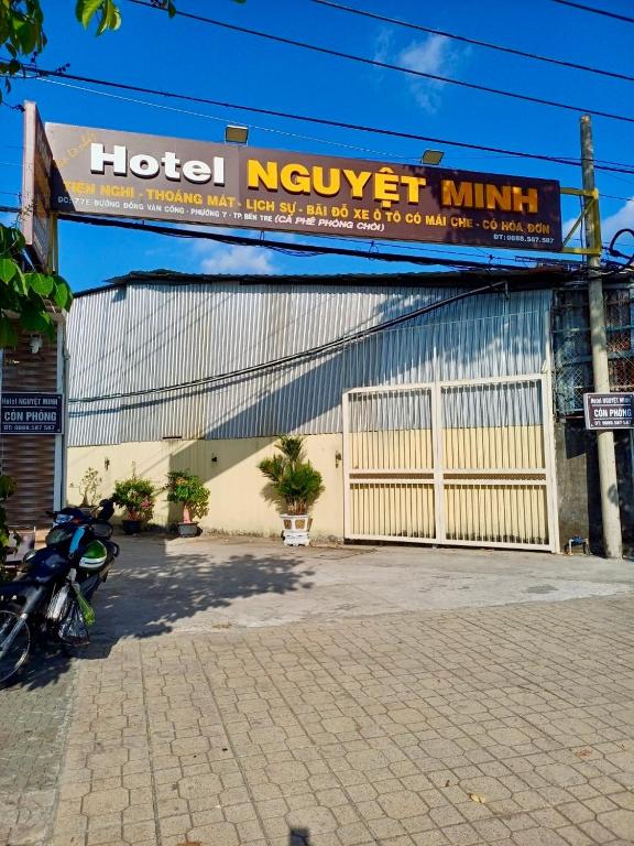 a building with a hotel norwegianillian sign on it at NGUYỆT MINH HOTEL in Ấp Phú Lợi