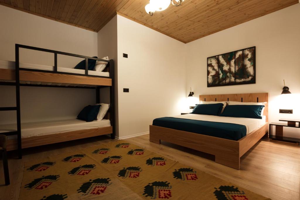 a bedroom with two bunk beds and a rug at The Barrels Ms in Gjirokastër