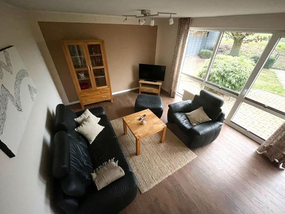 a living room with couches and a coffee table at Ferienhaus direkt an der Hase in Quakenbrück