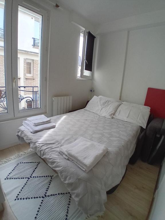 Ένα ή περισσότερα κρεβάτια σε δωμάτιο στο Paris 11 Studio