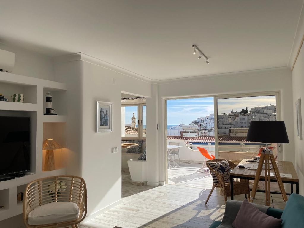 a living room with a view of a city at Ocean Balcony apartment terrace sea view and pool in Albufeira