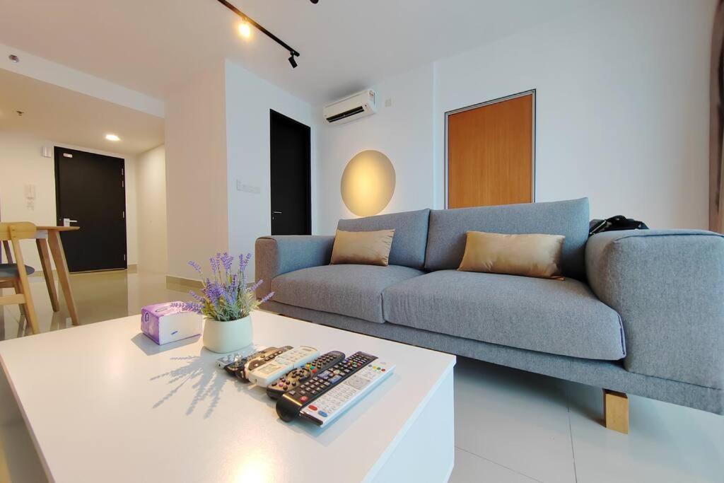 a living room with a blue couch and a coffee table at Setia Alam Walking Distance Convention Centre & Shopping Mall 2 Bedroom 2-4Pax in Shah Alam