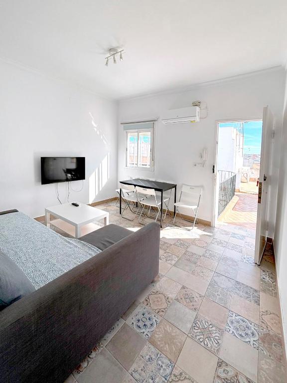 a bedroom with a bed and a table in it at Gran Teatro Falla in Cádiz