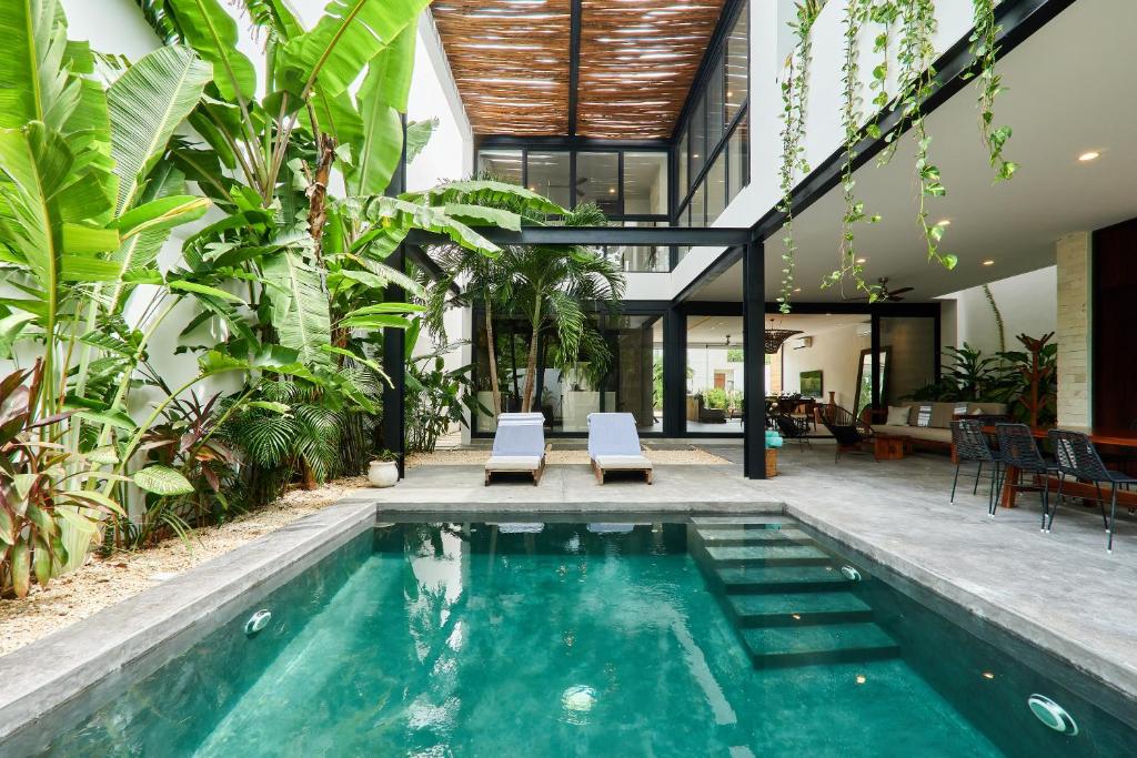 an indoor pool in a house with plants at Casa Aventura Secluded Oasis 24h Security Near Sandy Beaches in Tulum