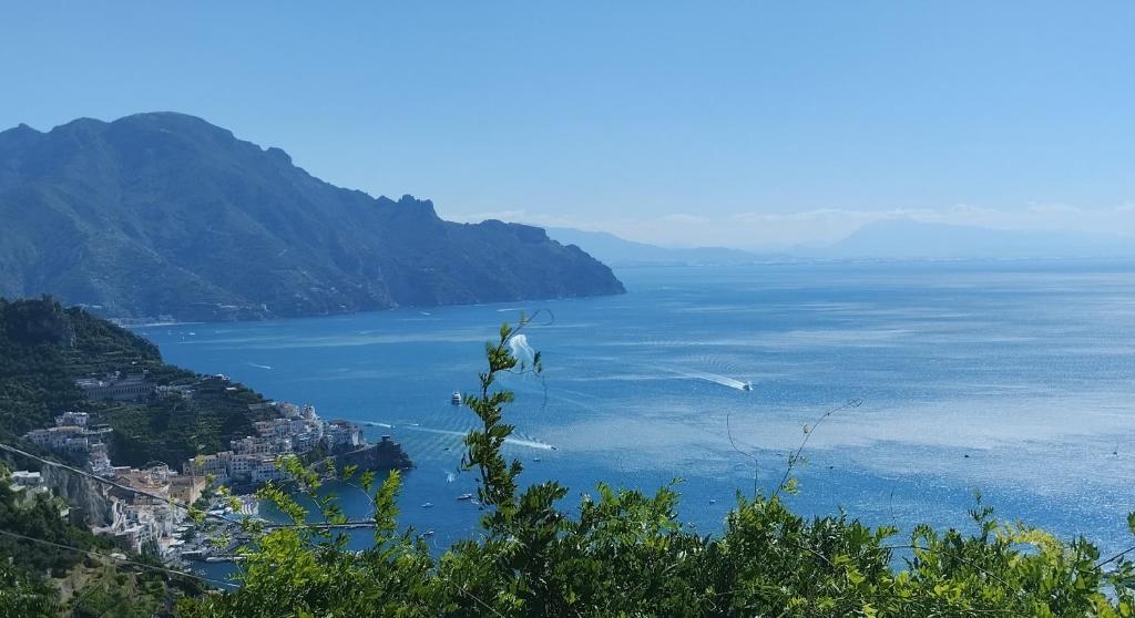 a view of a large body of water with mountains at IL PICCOLO INCANTO in Amalfi