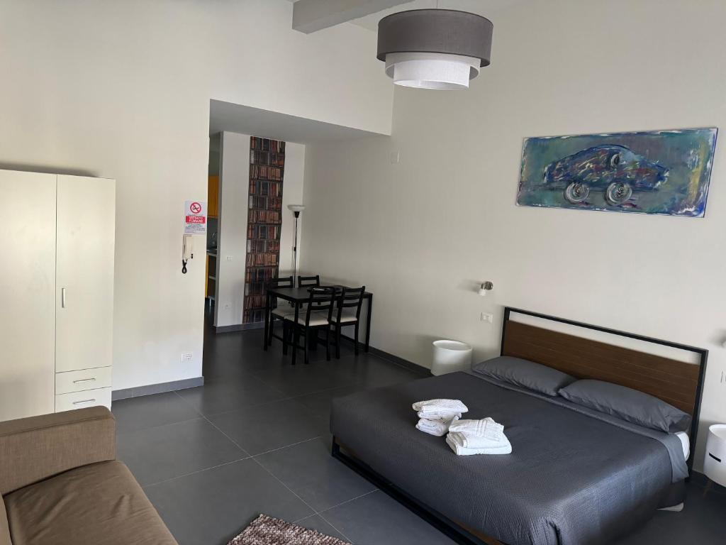 a bedroom with a bed and a table and chairs at Appartamenti ClesioResidenceBuonconsiglio in Trento
