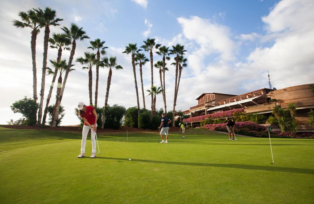 a group of people playing golf on a golf course at Sunny Sea View Apartment Center of Las Americas in Playa de las Americas