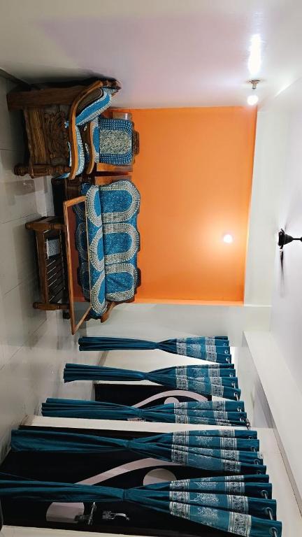 a closet with blue shirts hanging on a wall at BENARAS BILLS STAY INN... in Varanasi