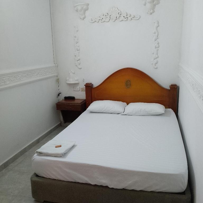 Postel nebo postele na pokoji v ubytování hotel avenida53