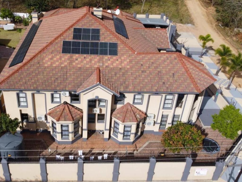 an aerial view of a house with solar panels on its roofs at Khutso Boutique Hotel in Hazyview
