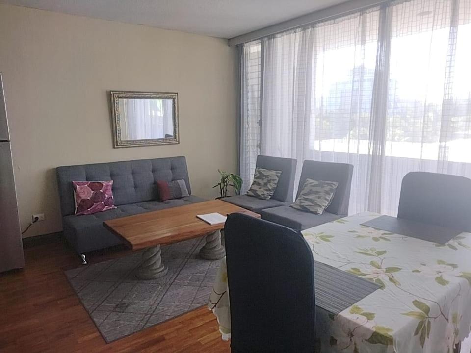 een woonkamer met een bank en een tafel bij Apartamento 505 Cortijo Reforma zona 9 in Guatemala