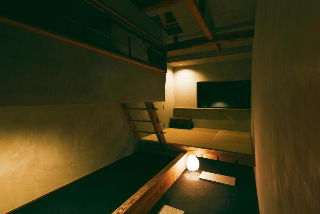 a dark room with a staircase and a light at kagelow Mt.Fuji Hostel Kawaguchiko in Fujikawaguchiko