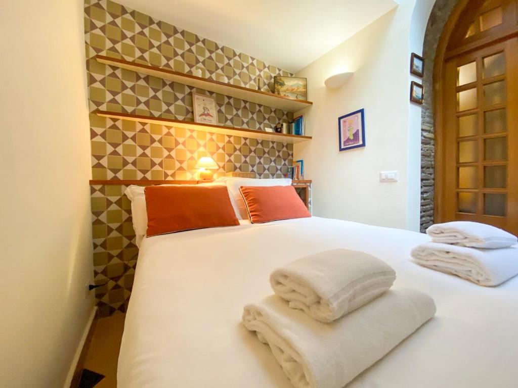 a bedroom with a white bed with towels on it at Le Petit Prince in Rome
