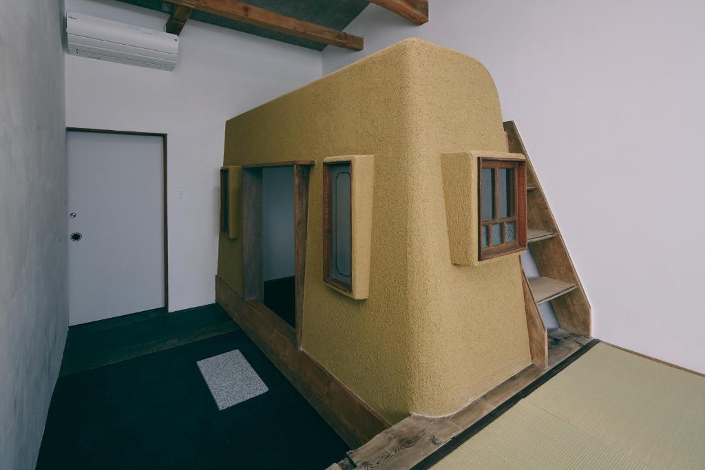 a room with a building with windows on the wall at kagelow Mt.Fuji Hostel Kawaguchiko in Fujikawaguchiko