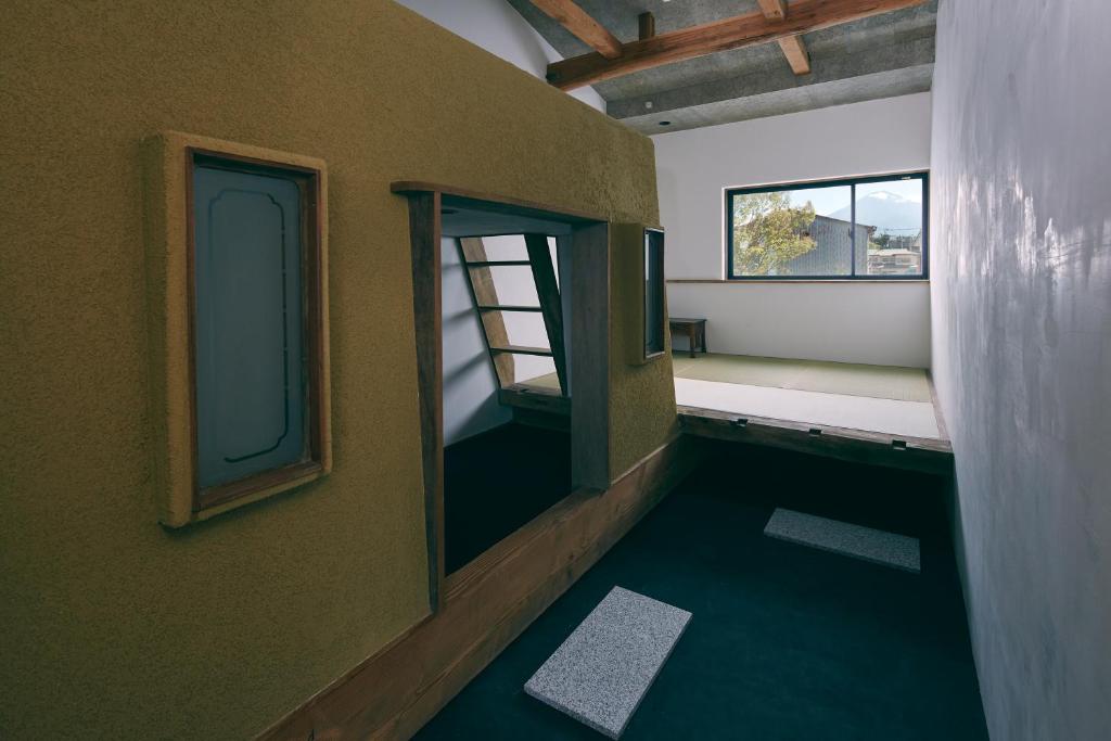 a small room with a window and a room with a window at kagelow Mt.Fuji Hostel Kawaguchiko in Fujikawaguchiko