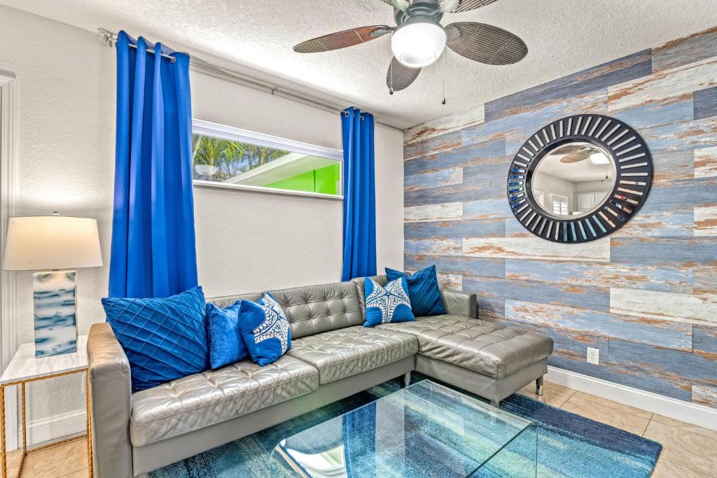 a living room with a couch and blue pillows at Luxury Suite| Beach| Fishing| Dock in St Pete Beach