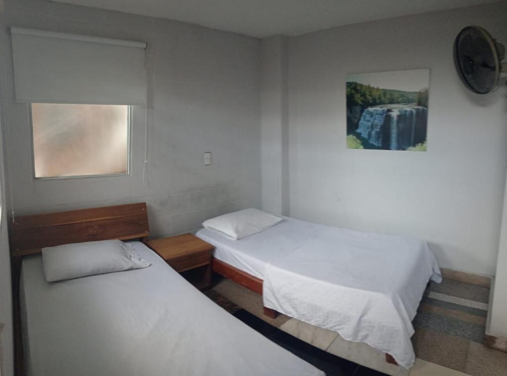 Posteľ alebo postele v izbe v ubytovaní HOTEL UNICO MEDELLIN S.A.S