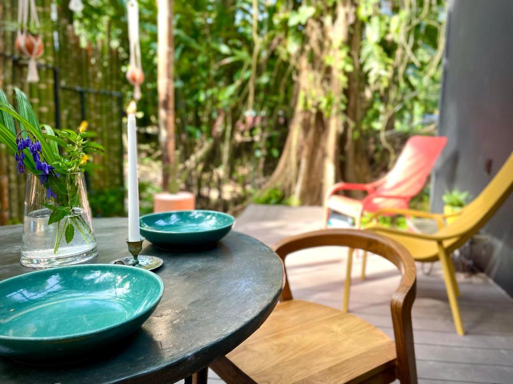 a table with two blue bowls on top of it at Casa Eden - Modern Peaceful Jungle Apartments in Cocles