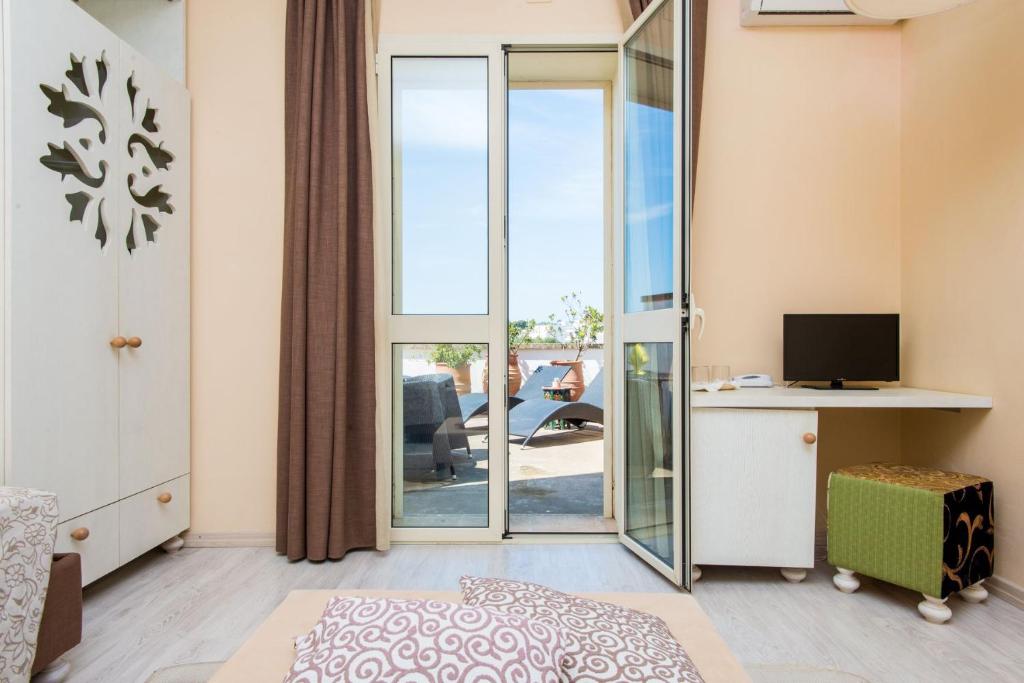 TV a/nebo společenská místnost v ubytování Approdo Boutique Hotel Leuca
