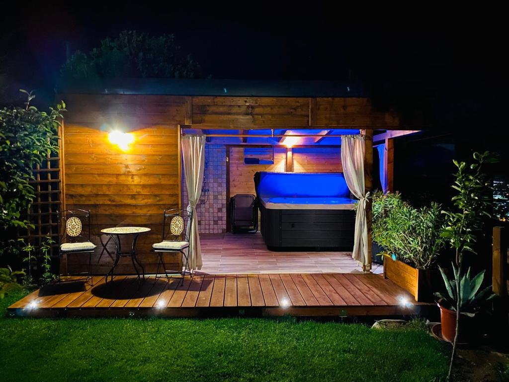 a bed on a deck in a backyard at night at Panoráma Vendégház in Pécs