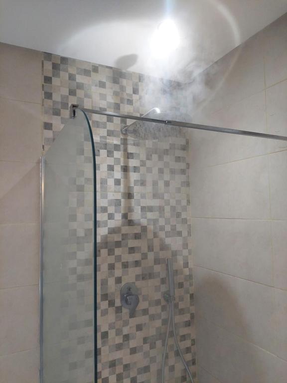 a shower with a glass door in a bathroom at Chabili Appartements in Temara
