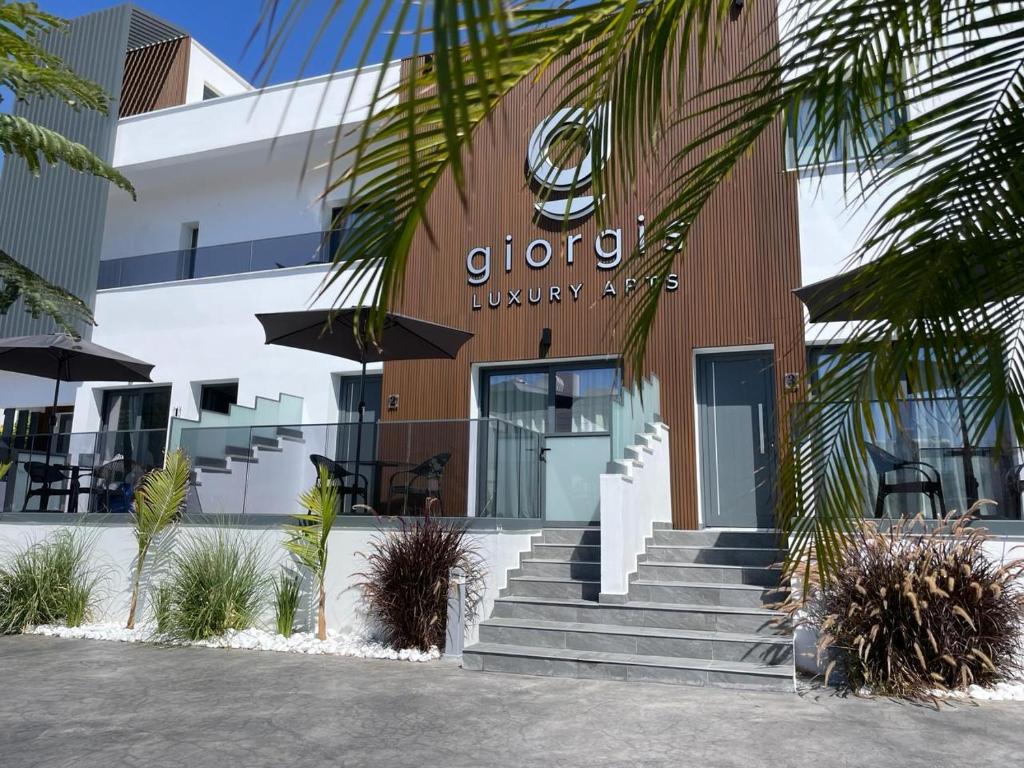 a building with stairs in front of a building at Giorgis Luxury Apartments in Ayia Napa