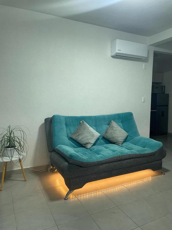 a blue couch in a living room with a light at Acapulco Dreamer Diamante II in Gallinero