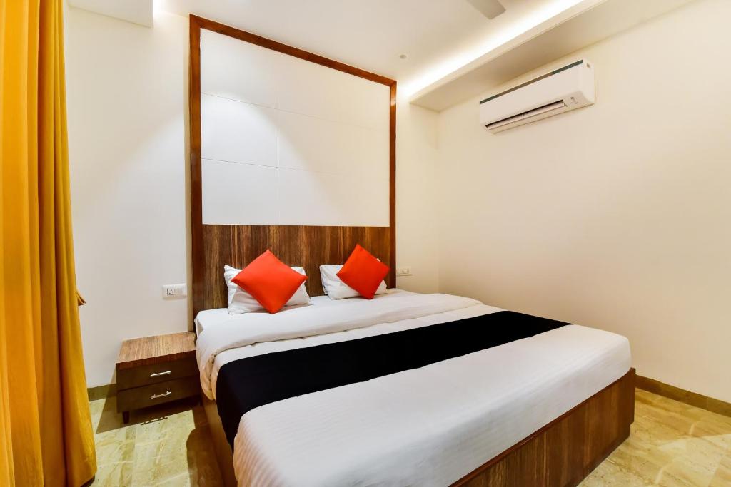 1 dormitorio con 1 cama grande con almohadas rojas en Maurya Inn en Jodhpur
