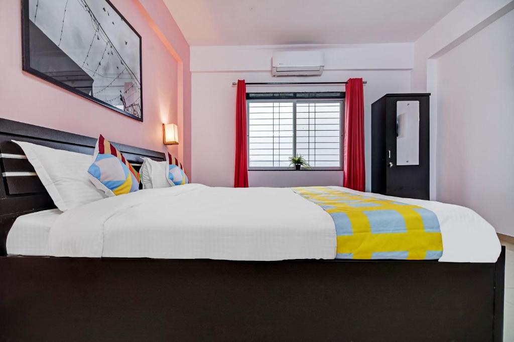 a bedroom with a large bed and a window at OYO Home Designer Stay Hinjewadi in Hinjewadi