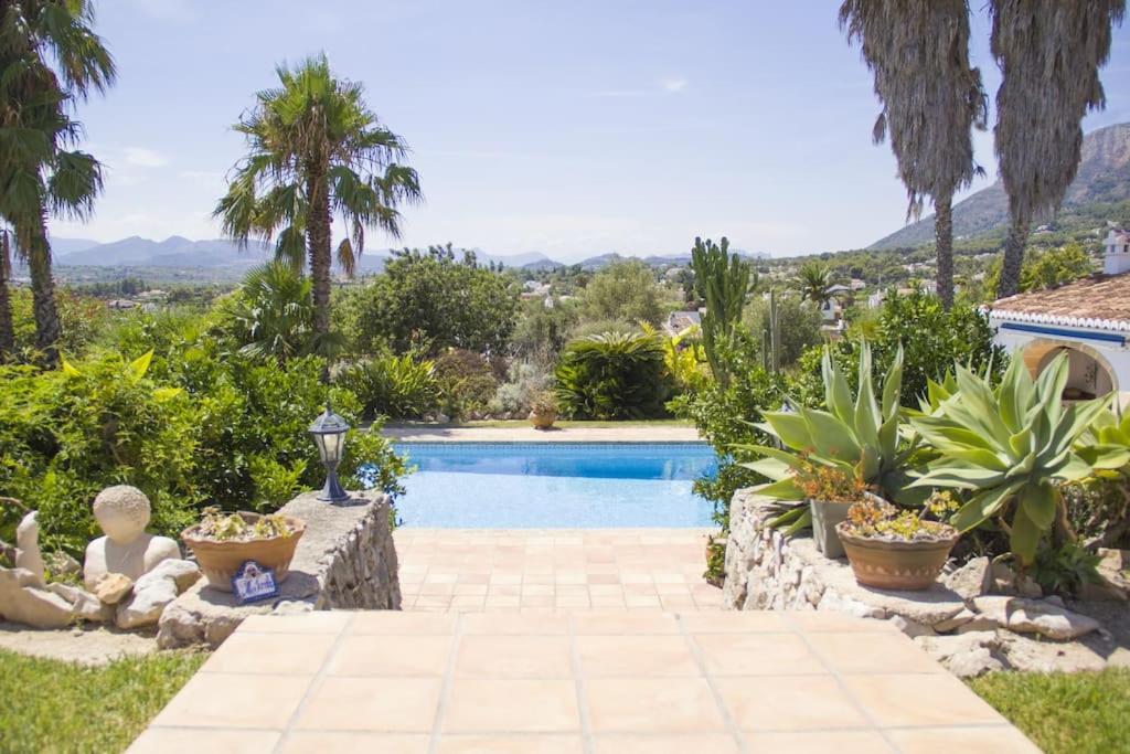 a swimming pool in a yard with plants at Villa with spectacular views in Jávea