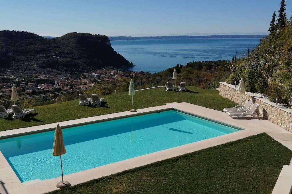 a swimming pool with a view of the water at Appartamenti Annachiara in Costermano