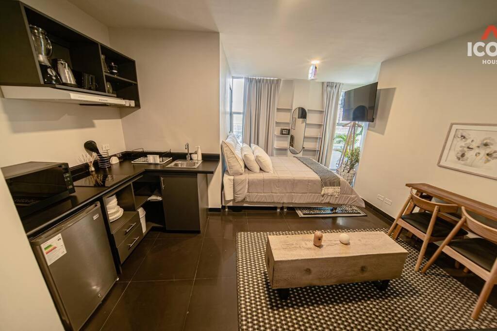 a kitchen and living room with a couch in a room at Bright Studio in Barranco in Lima