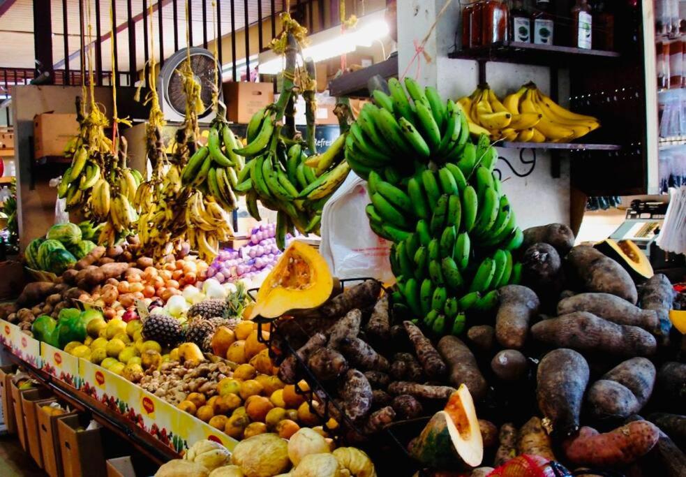 a display of fruits and vegetables in a market at Fiesta Spot at La Placita in San Juan