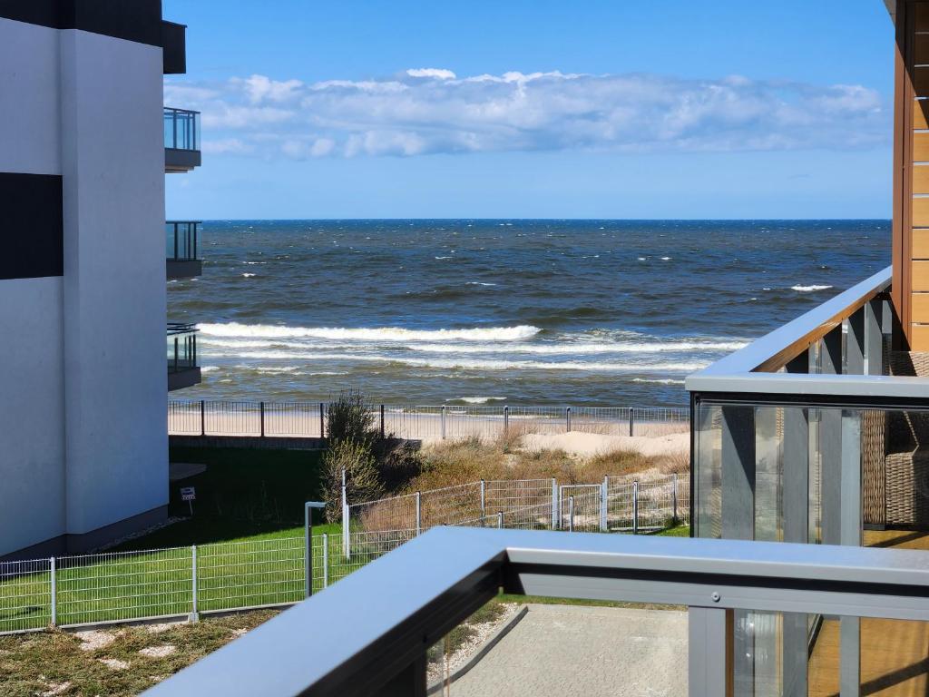 a view of the ocean from the balcony of a condo at Apartament TURKUSOWY Gardenia Dziwnów z widokiem na morze EPapartamenty in Dziwnów