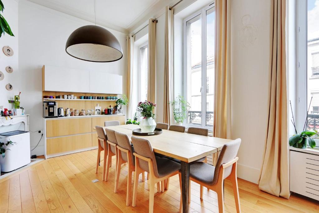 a kitchen and dining room with a table and chairs at Very nice apartment Atypical 6 People in Paris