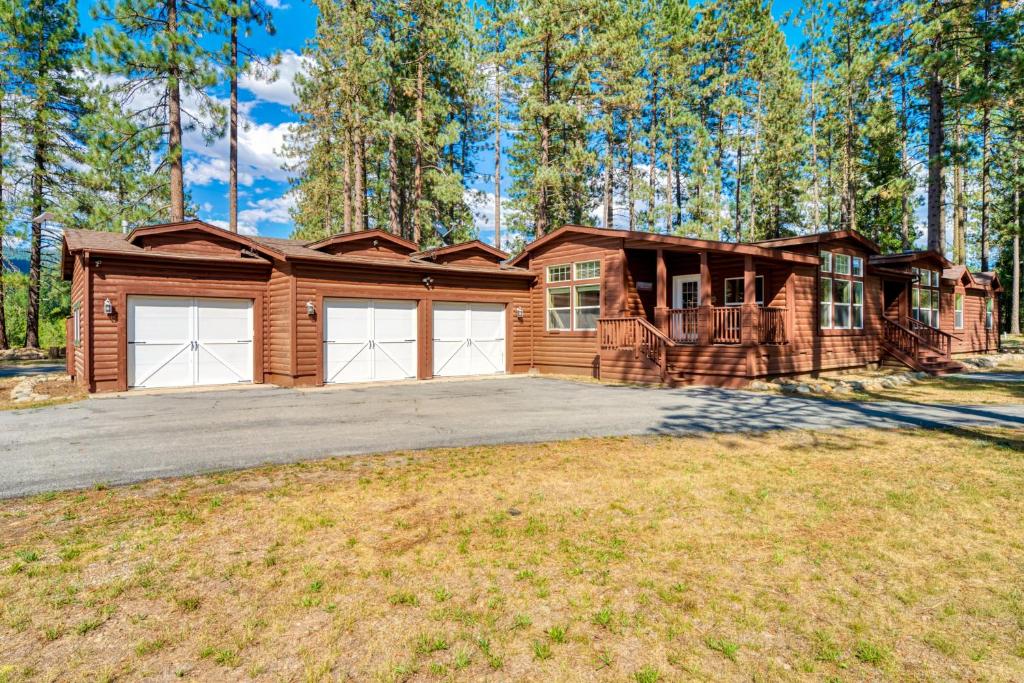 a house with two garage doors on a driveway at Feather House | The Lost Sierra Ranch in Graeagle