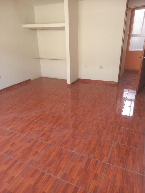 an empty room with a wooden floor at Alquiler de minidepartamento in Lima