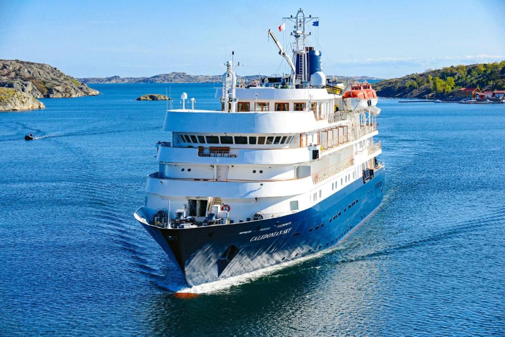 a large cruise ship in a body of water at Captain Cook Cruises Fiji in Denarau