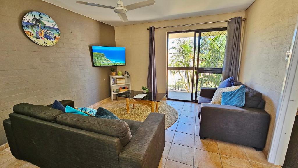 a living room with two couches and a tv at Riverview Holiday Apartment 112 - Kalbarri WA in Kalbarri