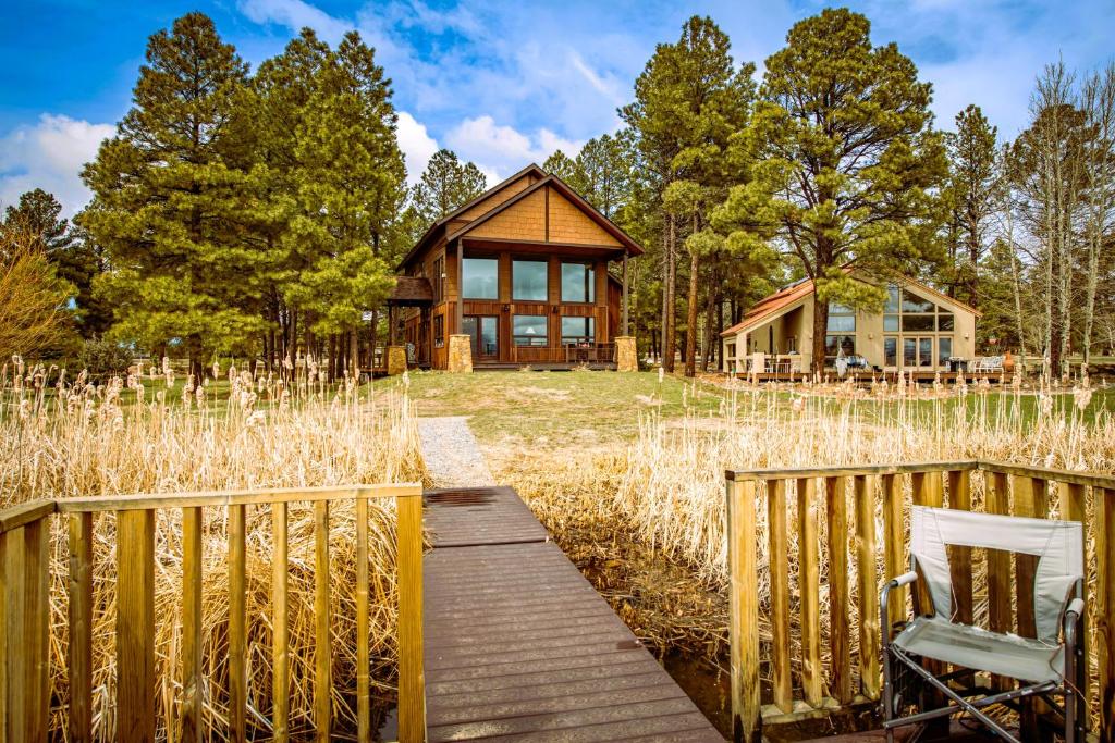 a wooden walkway leading to a wooden house at Casa Panchoy in Pagosa Springs