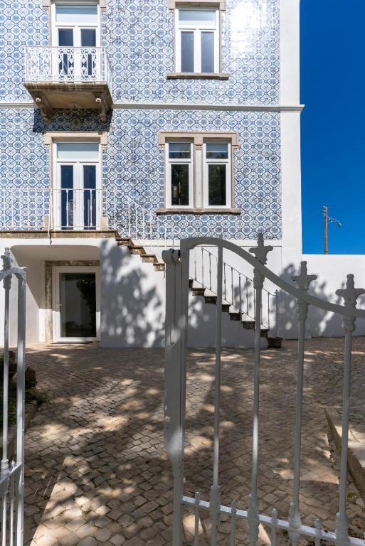 a blue and white building with a staircase in front of it at Come Inn Sintra in Sintra