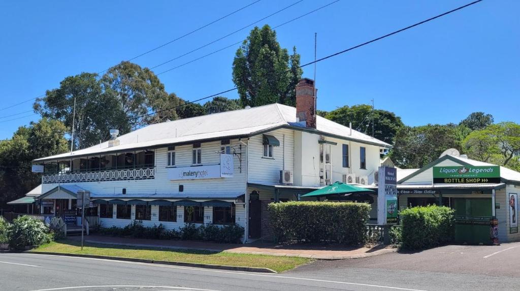 an old white building on the corner of a street at Maleny Hotel in Maleny